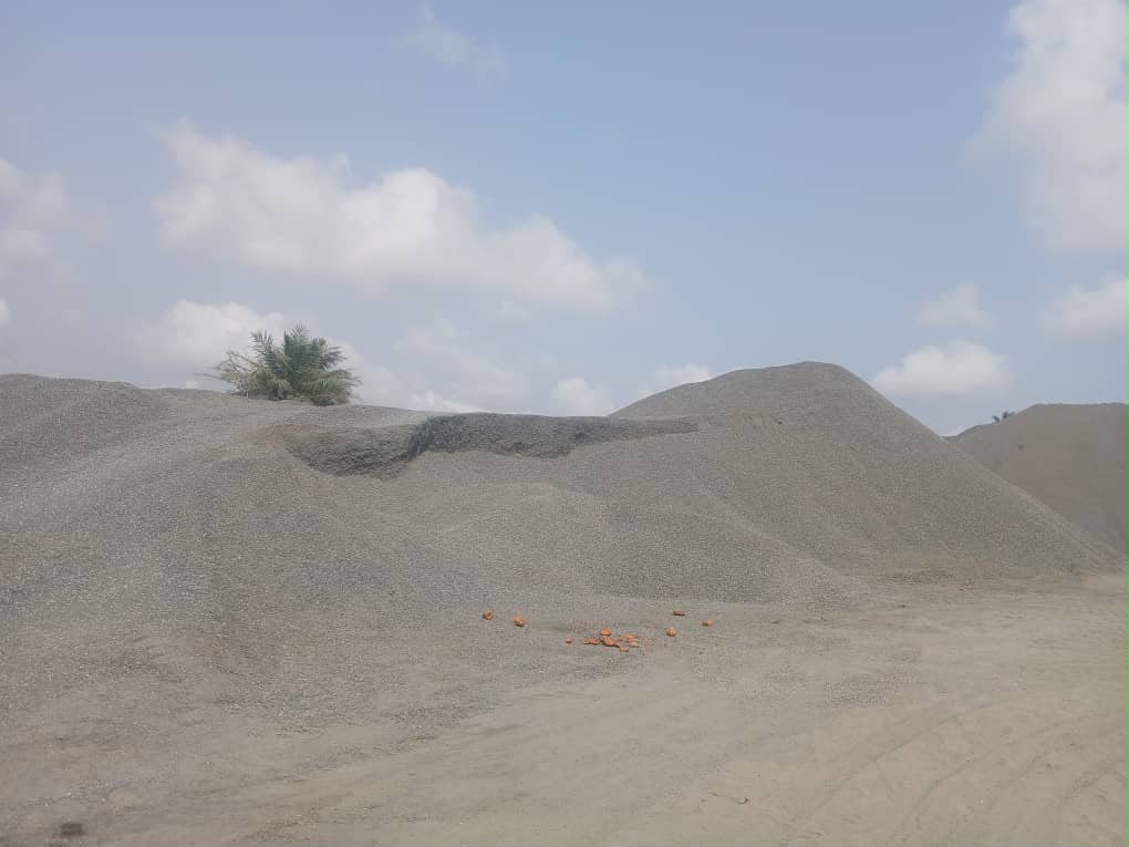 Aggregate stockpiles under a blue sky