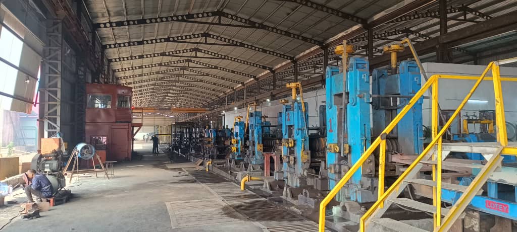 Rolling mill hall with rows of mill stands at an Odhav Group steel plant